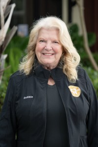 Large view of Debbie outside smiling.